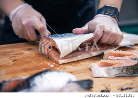 Chef preparing a salmon fish 88131333