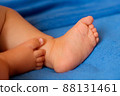 Children's legs on a blue veil close-up 88131461
