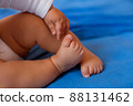Baby legs on the bed 88131462