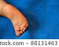 Baby legs on the bed 88131463
