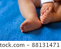 Children's legs on a blue veil close-up 88131471