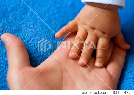 Hand of a child on a woman's palm 88131472