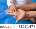 Hand of a child on a woman's palm 88131474