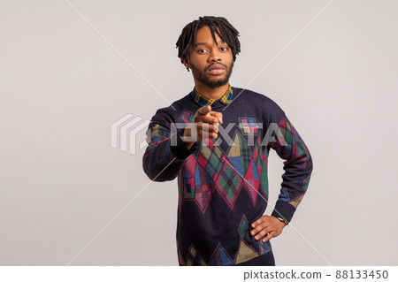 You can. Serious bossy african man with beard and dreadlocks pointing finger at camera, motivating and inspiring, commanding. Indoor studio shot isolated on gray background 88133450