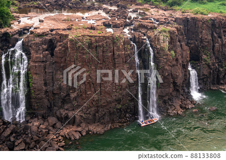 Boat with tourists at the Iguazu Falls in Brazil 88133808