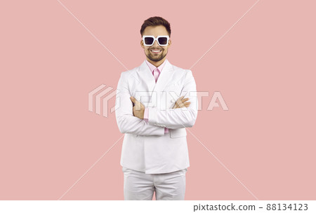 Happy man in suit and glasses on pink background 88134123