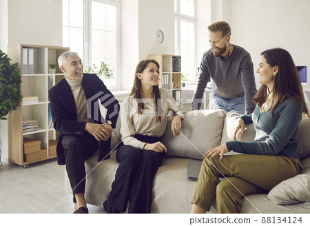 Smiling diverse employees discuss ideas in cozy office 88134124