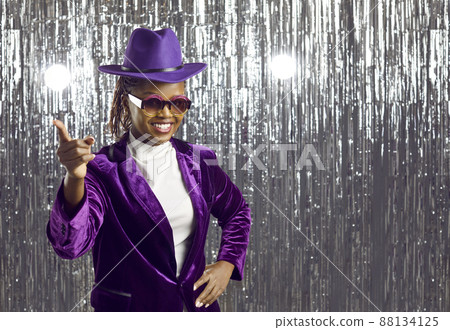 Funny woman in trendy velvet clothes waving her index finger in front of camera on silver background 88134125