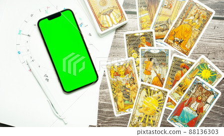 The concept of divination, magic and esotericism. Natal chart smartphone with Green screen tarot cards. 88136303