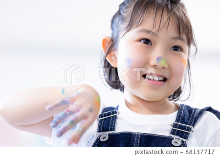 一個在大畫紙上用顏料畫畫的女孩 88137717
