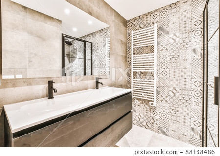 Luxurious bathroom interior with large sink and beige tiles 88138486