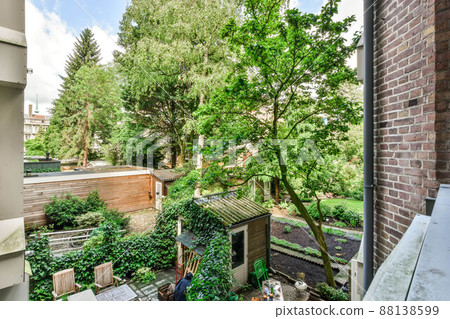 View from the balcony to the backyard with a cozy interior and beautiful nature 88138599