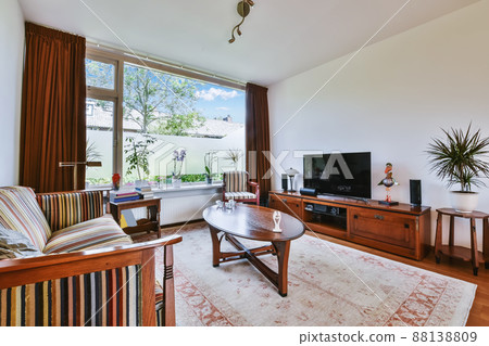 Lovely living room with wooden coffee table and window 88138809
