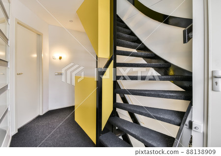 Spacious hallway with stairs and carpet on the floor Spacious hallway with stairs and carpet on the floor 88138909