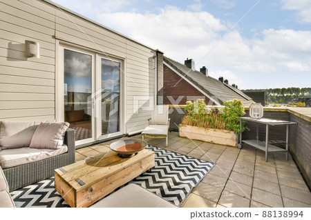 Cozy place to relax on the roof of a modern house with a corner sofa and a pleasant interior 88138994
