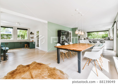 The interior of a beautiful dining room with large windows and parquet floors 88139049