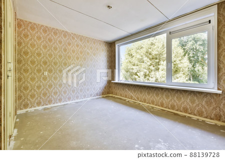 A delightful room with beige wallpaper on the wall in daylight A delightful room with beige wallpaper on the wall in daylight 88139728