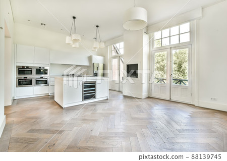 beautiful kitchen in new luxury home with island, pendant lights, hardwood floors, and stainless steel appliances 88139745