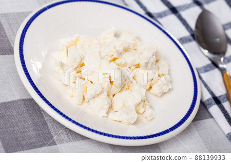 Young type of cheese on plate 88139933