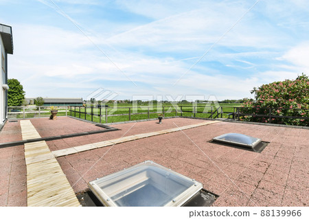 Spacious veranda overlooking a huge field and outdoor trees 88139966