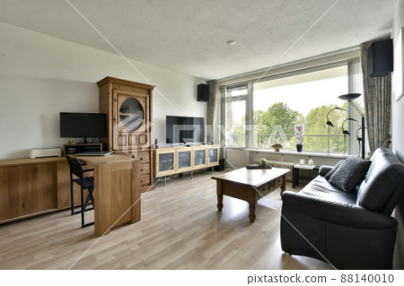 Living room combined with work area. Living room with wooden furniture and leather sofa 88140010