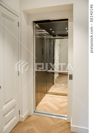 Corridor with parquet floors and a small elevator in a modern house Corridor with parquet floors and a small elevator in a modern house 88140146