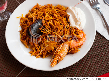 Dish of Valencian cuisine Fideua with seafood and noodles Dish of Valencian cuisine Fideua with seafood and noodles 88140153