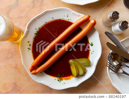 Pair of Viennese sausages with saft goulash on plate 88140197