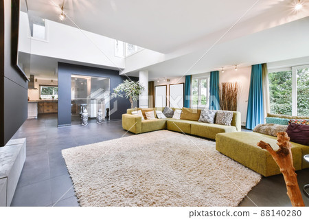 Cozy large living room with a yellow sofa in daylight Cozy large living room with a yellow sofa in daylight 88140280