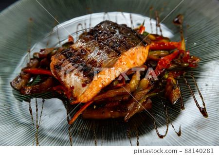 Portion of salmon steak with stewed vegetables Portion of salmon steak with stewed vegetables 88140281