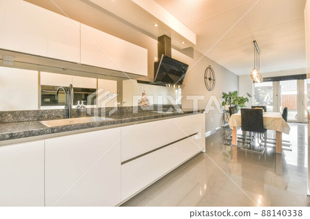 Kitchen with glossy white furniture and all appliances 88140338