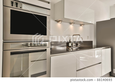Spacious and cozy minimalist open-plan kitchen in a modern house Spacious and cozy minimalist open-plan kitchen in a modern house 88140693
