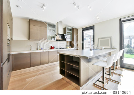 Luxurious kitchen from the island in a modern style and with all the necessary equipment for cooking Luxurious kitchen from the island in a modern style and with all the necessary equipment for cooking 88140694