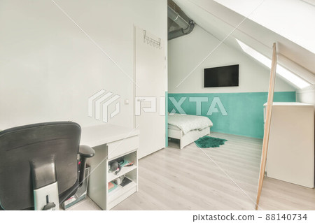 Modern room in the attic of a house with white furniture and white walls 88140734
