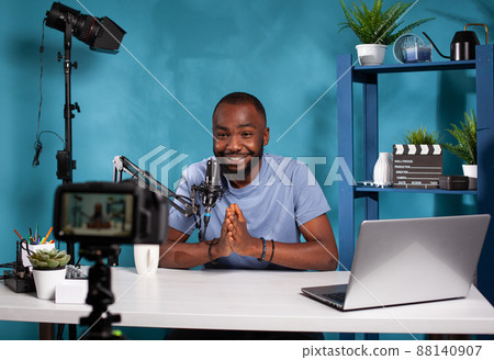 Vlogger saying thank you to audience in front of recording digital video camera at the end of online live show. Social media content creator doing closing line finishing video podcast. Vlogger saying thank you to audience in front of recording digital video camera at the end of online live show. Social media content creator doing closing line finishing video podcast. 88140907