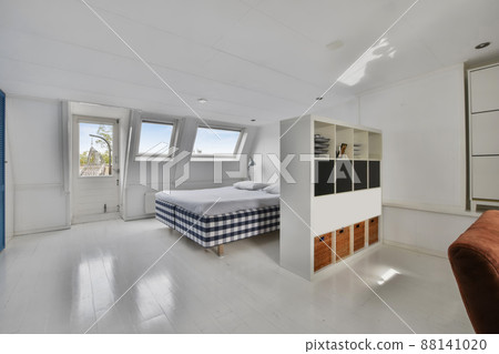 a large attic bedroom with a comfortable double bed 88141020
