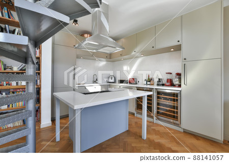 Modern kitchen with fitted gray style cabinets and all the necessary equipment Modern kitchen with fitted gray style cabinets and all the necessary equipment 88141057