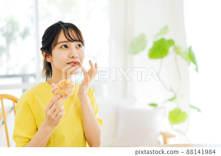 A woman eating a donut A woman eating a donut 88141984