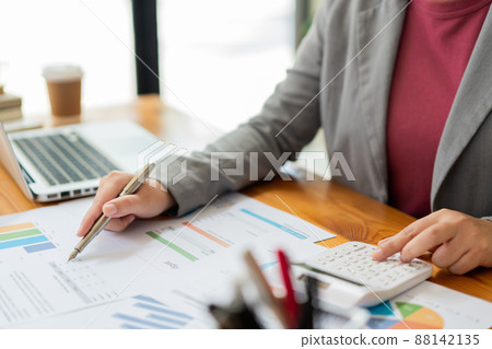 Business analyst concept the data analyst calculating the diagrams about the sale on the paperwork 88142135