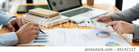 Business negotiation concept the female broker estimating the number of estate and checking it with the male broker 88142137