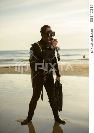 diver rescue in wetsuit  equipment for scuba diving.  88142315