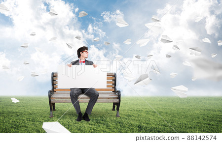 young businessman with an empty poster young businessman with an empty poster 88142574