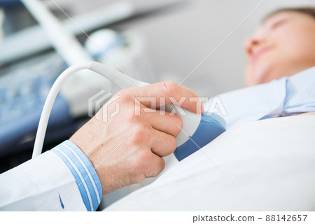 Doctor doing ultrasound screening checkup Doctor doing ultrasound screening checkup 88142657