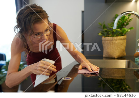 Woman Cleaning Kitchen Counter 88144630