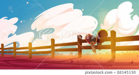 Horse saddle hanging on wooden ranch fence scene 88145130