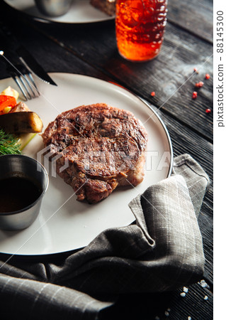 Grilled beef steak with vegetable garnish Grilled beef steak with vegetable garnish 88145300