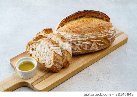 Bread that has been cut and placed on a cutting board 88145942