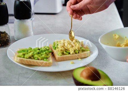 Woman prepare toasts with avocado, Healthy nutrition Woman prepare toasts with avocado, Healthy nutrition 88146126