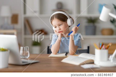 Girl doing homework or online education. 88146407