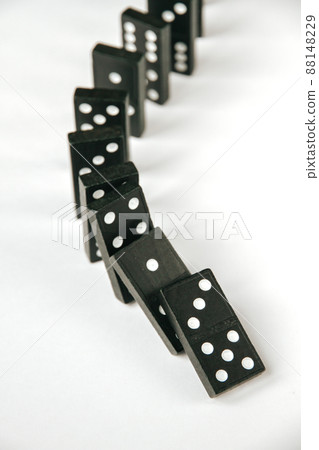 Black dominoes chain on white table background 88148229